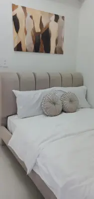 a bed with white sheets and two pillows at 2 Bedroom Unit at Central Makati in Manila
