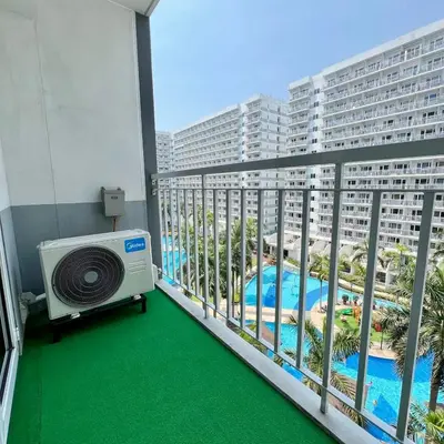a room with a balcony with a air conditioner at OASIS by JK Suites in Manila