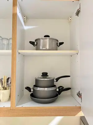 a pot and pans sitting on a shelf in a kitchen at SKYLINE by JK Suites in Manila