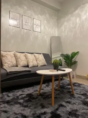 a living room with a couch and a coffee table at The Ren Suite Facing Sunrise or City View in Manila