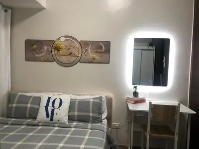 a bedroom with a bed and a mirror on the wall at Corner 1Bedroom with Unparalleled Views #5235 in Manila