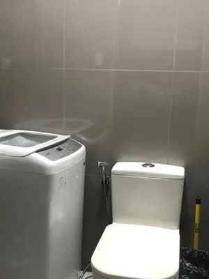 a bathroom with a white toilet and a sink at Corner 1Bedroom with Unparalleled Views #5235 in Manila