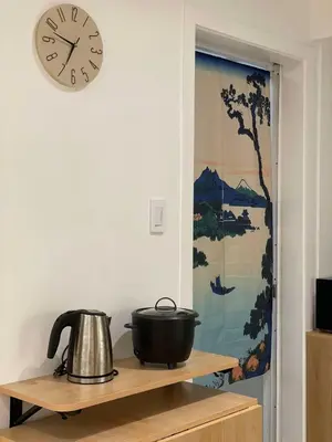 a clock on a wall with a pot on a shelf at Supreme Luxury 2BR Condo - Azure Urban Resort Residences near Manila Airport in Manila