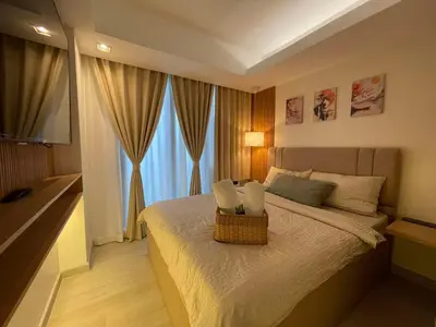 a bedroom with a bed with a basket on it at Supreme Luxury 2BR Condo - Azure Urban Resort Residences near Manila Airport in Manila