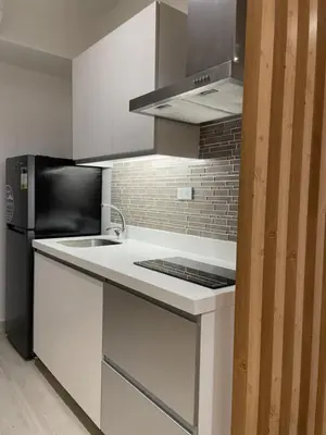a kitchen with a stove and a refrigerator at Supreme Luxury 2BR Condo - Azure Urban Resort Residences near Manila Airport in Manila