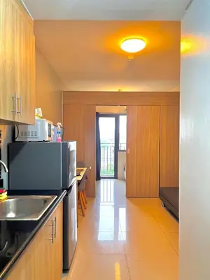 a kitchen with a sink and a microwave at Shore 8109 onebedroomwbalcony in Manila