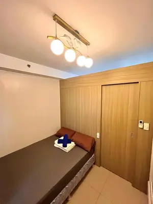a room with a bed with a blue item on it at Shore 8109 onebedroomwbalcony in Manila