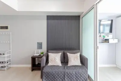 a living room with a couch and a table at Cee Staycation in the City - Azure Maui Penthouse in Manila