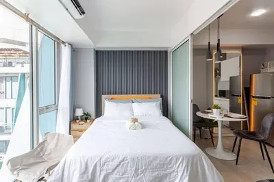 a bedroom with a bed with a teddy bear on it at Cee Staycation in the City - Azure Maui Penthouse in Manila
