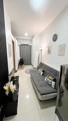 a living room with a couch and a table at Condo with Mall in Manila