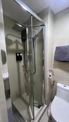 a shower stall in a bathroom with a toilet at Condo with Mall in Manila