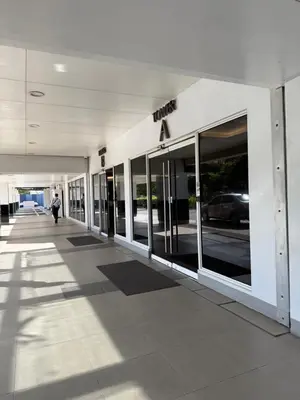 an empty hallway of a building with glass windows at Zeth's Place at Shell Residences Near MOA and NAIA in Manila