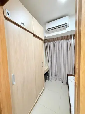 a room with wooden doors and a window at Zeth's Place at Shell Residences Near MOA and NAIA in Manila