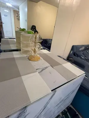 a table with a mirror and a vase on it at FamBnb in Manila