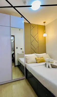 a room with a large bed with a mirror at dream horizon staycation in Manila