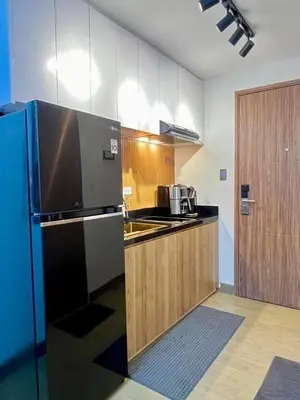 a kitchen with a refrigerator and a counter top at dream horizon staycation in Manila