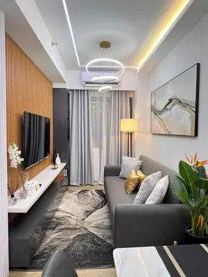a living room with a couch and a tv at dream horizon staycation in Manila