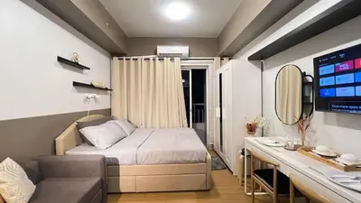 a small bedroom with a bed and a desk at 2243 Taguig Condo Near Airport and BGC in Manila