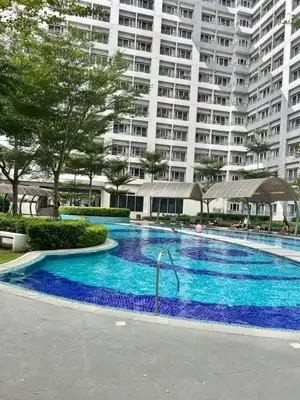 a large swimming pool in front of a large building at 2243 Taguig Condo Near Airport and BGC in Manila