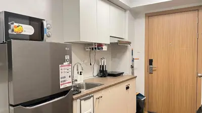 a kitchen with a refrigerator and a sink at 2243 Taguig Condo Near Airport and BGC in Manila