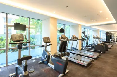 a gym with a row of treadmills and elliptical machines at Newport Stay by Runway Manila & Attractions in Manila