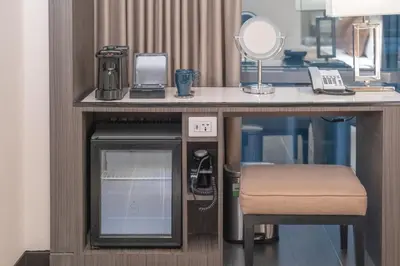 a room with a desk with a phone and a mirror at Newport Stay by Runway Manila & Attractions in Manila