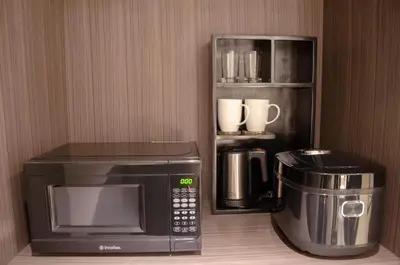 a kitchen with a microwave and a coffee maker at Newport Stay by Runway Manila & Attractions in Manila