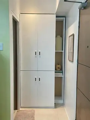 a white cabinet in a room with a kitchen at Stad en Thuis - Mckinley Hill, Taguig in Manila