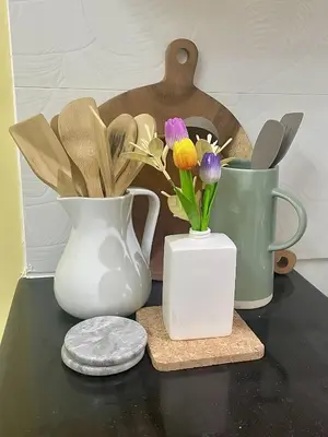 three vases sitting on a table with flowers in them at Stad en Thuis - Mckinley Hill, Taguig in Manila