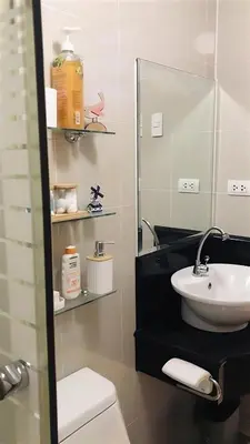 a bathroom with a sink and a mirror at Stad en Thuis - Mckinley Hill, Taguig in Manila