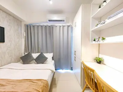 a small bedroom with two beds and a window at 1BR Condotel with Balcony at FAME Residences #FM16-1 in Manila