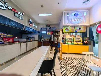 a fast food restaurant with a table and chairs at 1BR Condotel with Balcony at FAME Residences #FM40-1 in Manila