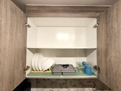 a cupboard filled with lots of kitchen utensils at 1BR Condotel with Balcony at FAME Residences #FM40-1 in Manila