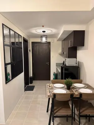 a kitchen with a table and chairs in a room at NFr in Manila