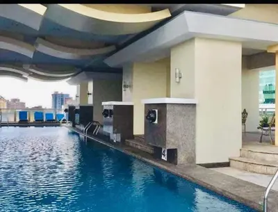 a swimming pool with a water slide in a building at Birch Tower a9 front of Robinson PlaceRizal park in Manila