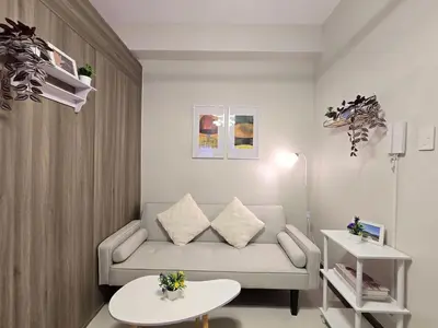 a living room with a couch and a table at 1BR Condotel with Balcony at FAME Residences #FM62-1 in Manila