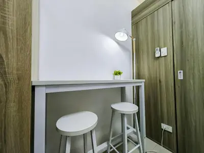 a bar in a room with two stools at 1BR Condotel with Balcony at FAME Residences #FM01-1 in Manila