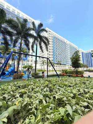 a playground in front of a large building at Sea Residences Manila Condotel by Paul in Manila