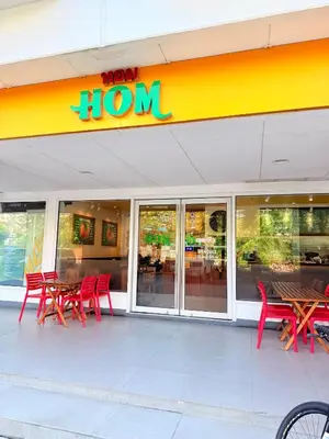 a restaurant with red chairs and tables in front of it at Sea Residences Manila Condotel by Paul in Manila