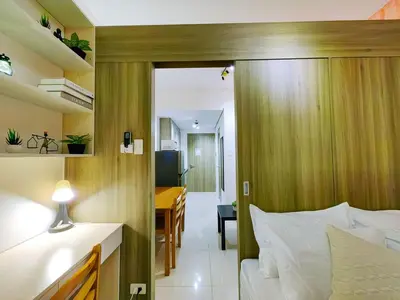 a bedroom with a bed and a desk in a room at 1BR Condotel with Balcony at FAME Residences #FM02-1 in Manila