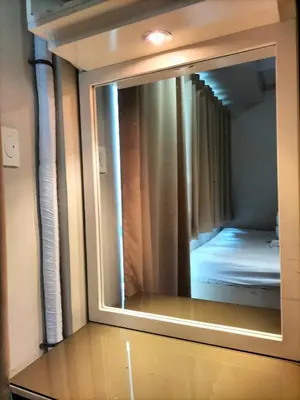 a mirror on top of a dresser in a room at Shell Residences MOA - JOSH in Manila