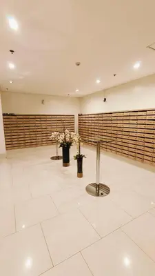 a large room with three vases with flowers in it at Shell Residences MOA - JOSH in Manila