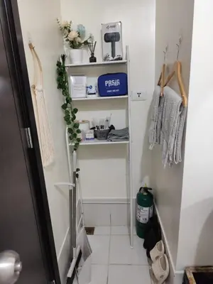 a small hallway with a white floor and a shelf at Pet Friendly Staycation at Pasig City in Manila