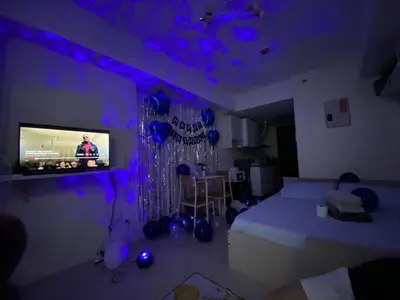 a room with a bed and a tv with purple lights at Pet Friendly Staycation at Pasig City in Manila