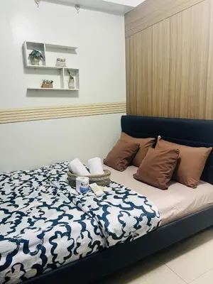 a bed with a blue headboard in a bedroom at City Solace in Manila