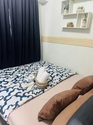 a bedroom with a bed with a hat on it at City Solace in Manila