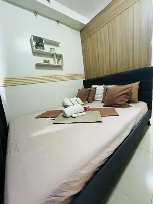 a large bed with towels on it in a room at City Solace in Manila