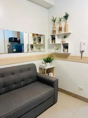 a living room with a couch in a room at City Solace in Manila