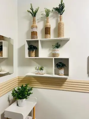 a room with white shelves with plants on them at City Solace in Manila