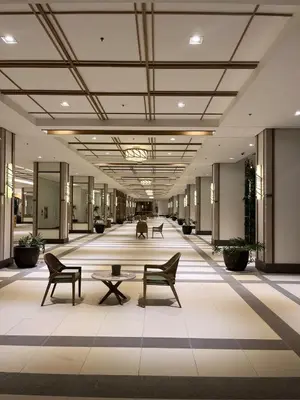 a hallway with chairs and tables in a building at 86 sqm, 3BR condo, Free Prking, WiFi, ntflx in Manila
